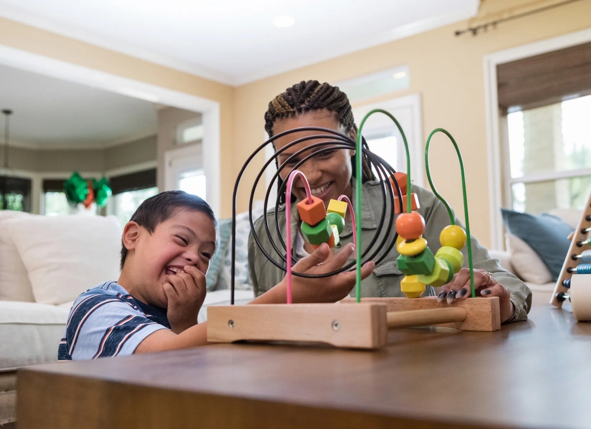 Occupational therapist working with a child on fine motor skills