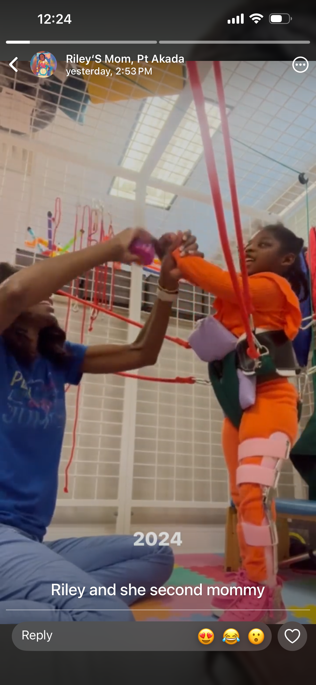 Physical therapist helping a child with movement exercises